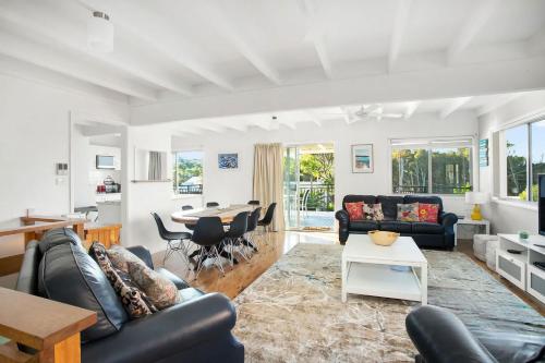 a living room with a couch and a table at MeNo's at Bawley in Bawley Point