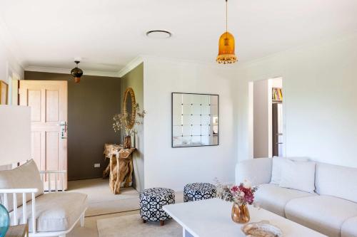 a living room with a couch and a table at Point Break in Bawley Point