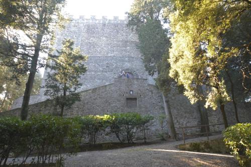 an old stone building with a tower on top of it at Borgo della Rocca in Montemurlo