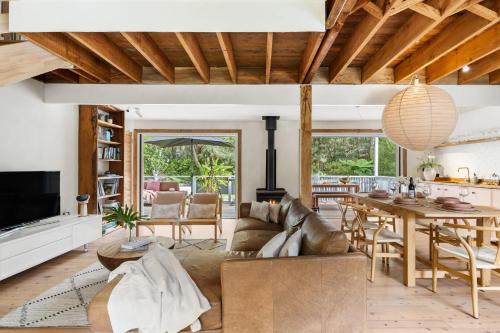 a living room with a couch and a table at Coastal Soul in Narrawallee