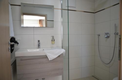a bathroom with a sink and a shower at Seebrise mit Musik und Wein in Meersburg