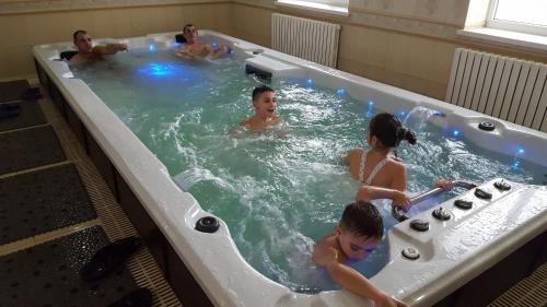 a group of people in a hot tub at Hotel Confort Drochia in Drochia