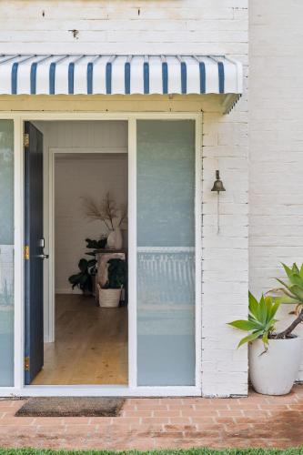 a sliding glass door of a house with a porch at Lilly Pilly at Callala Beach in Callala Beach