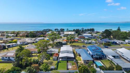 an aerial view of a town with houses and the ocean at Mare Mio Callala Beach Jervis Bay in Callala Beach