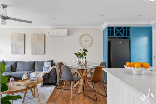 a kitchen and living room with a table and a couch at Kangaroo Sanctuary in Sanctuary Point