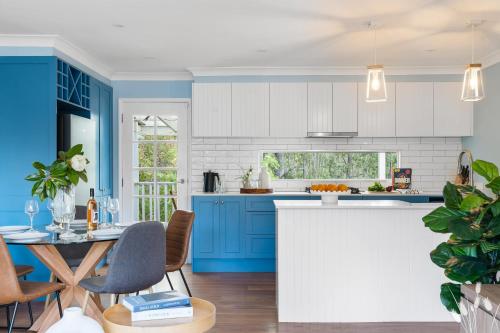 a kitchen with blue cabinets and a blue island at Kangaroo Sanctuary in Sanctuary Point