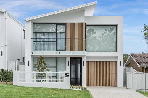 a contemporary house with a white facade at Beachside on Beecroft in Huskisson