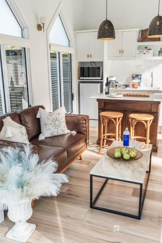 a living room with a couch and a table at Chapel by the Bay in Erowal Bay