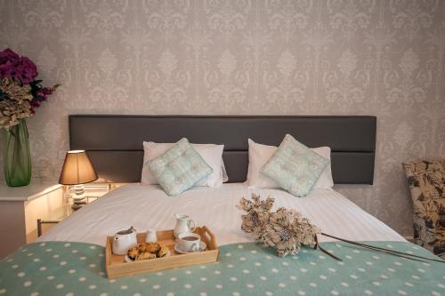 a bed with a tray of food on it at The Royal Hotel and Bar in Lancaster
