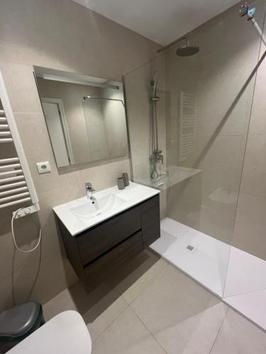 a bathroom with a sink and a shower at Casa Flores in El Campello