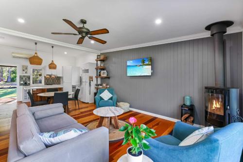 a living room with two blue couches and a fireplace at The Shack - Myola in Myola