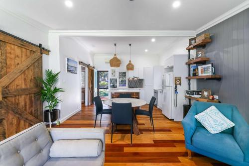 a living room with a table and a blue couch at The Shack - Myola in Myola