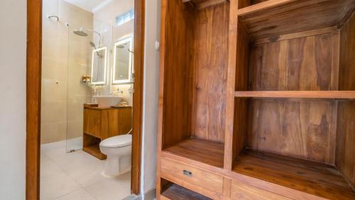 a bathroom with a toilet and a shower and a sink at Sriwedari 40 Ubud in Ubud