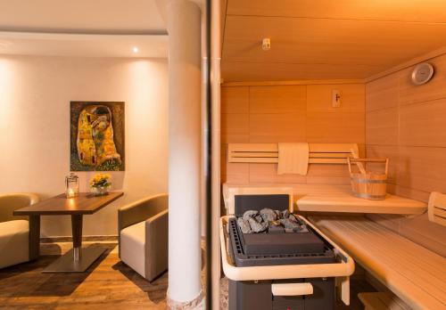a small room with a sauna with a table and a table at Göbels Schlosshotel "Prinz von Hessen" in Friedewald