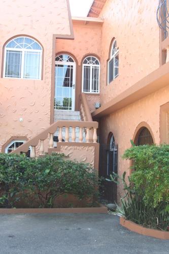 a house with a staircase on the side of it at Cozy Apartment in Kingston