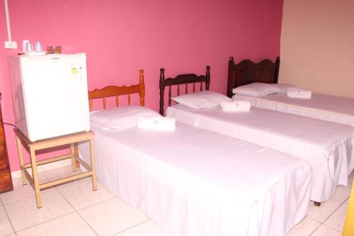 En eller flere senge i et værelse på Pousada Familiar Encanto da Chapada