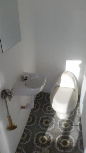 a bathroom with a white toilet and a sink at El Nido Bayview in El Nido