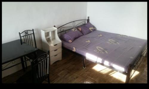 a bedroom with a bed and a dresser and a desk at El Nido Bayview in El Nido