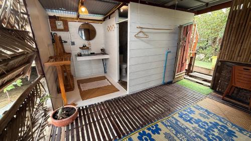 a tiny house with a bathroom and a porch at Deep House Sea View in Ko Lanta