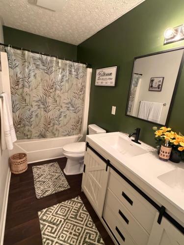 a bathroom with a shower and a toilet and a sink at Marvielous Stay in Jacksonville