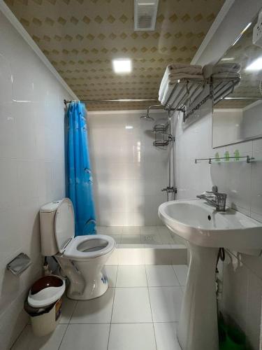 a bathroom with a toilet and a sink at Polvon Ota Hotel in Khiva