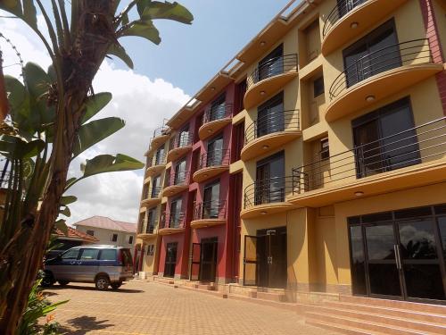 a van parked in front of a building at Olina Hotel and Apartments Kampala in Kampala