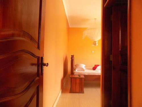 an open door to a bedroom with a bed at Olina Hotel and Apartments Kampala in Kampala
