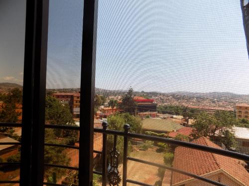 a view of a city from a window at Olina Hotel and Apartments Kampala in Kampala