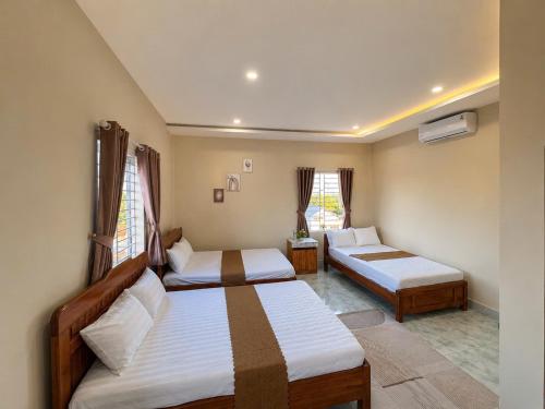 a bedroom with two beds and a window at Đại Thắng Hotel in Danang