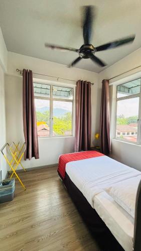 a bedroom with a bed and a ceiling fan at Seaview Apartment in Kuah