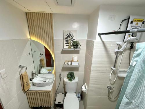 a small bathroom with a toilet and a sink at H4R1 Luxe Haven in Bacolod