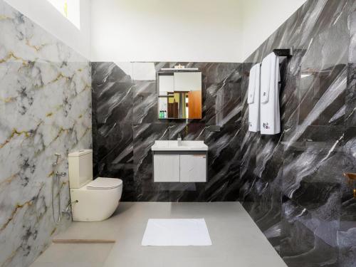 a bathroom with a toilet and a sink at Mashmellow Resort and Spa in Galle