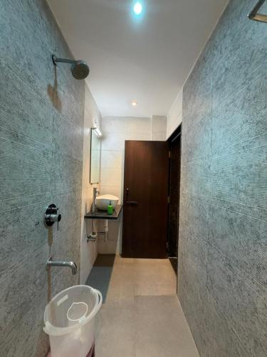 a bathroom with a toilet and a sink at The Berry House in Satara