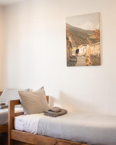 a bedroom with two beds and a picture on the wall at Ethico Retreat Formely Five14 BnB in Pātan