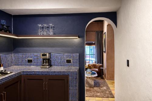 a kitchen with blue tiled walls and an archway at Casa UMA in San Miguel de Allende