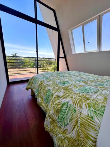 a bedroom with a bed with a view of the ocean at A Frame house Perú in Lambayeque
