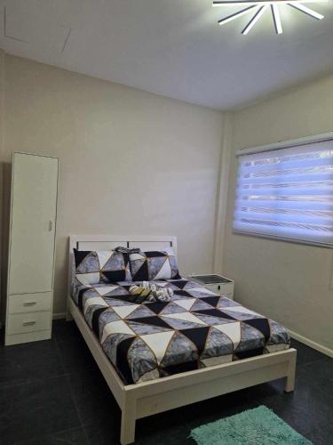 a bedroom with a bed and a ceiling fan at S & R Homes in Tacloban