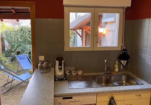 a kitchen counter with a sink and a window at 32-La Place To Be in Senlis