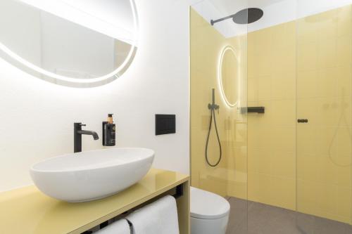 a bathroom with a white sink and a shower at Ferienwohnungen Steinegg in Lagundo