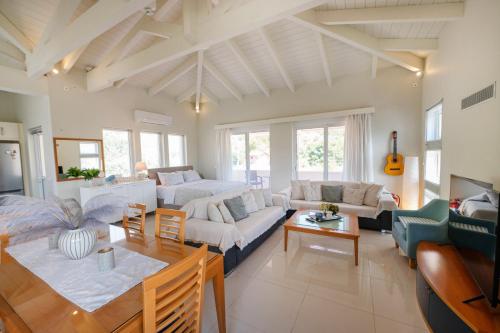a living room with a couch and a table at Sunray Poros in Poros