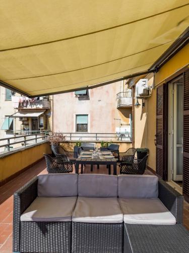 a patio with a couch and a table on a balcony at Casa Silvia in Bracciano