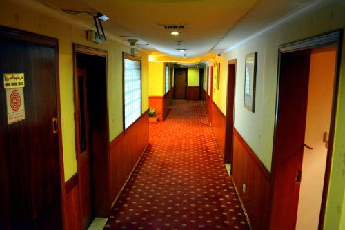 a hallway with a red floor in a building at York International Hotel in Dubai