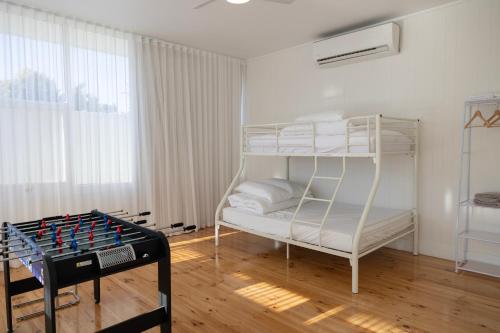 a bedroom with a bunk bed and a chess board at Belle Escapes Henley's Coastal Charm in Henley Beach South