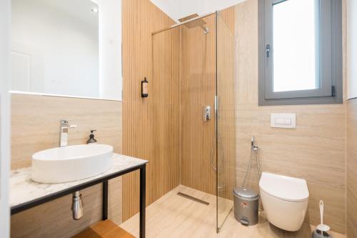 a bathroom with a sink and a toilet at Riverside Villa in Tragjas