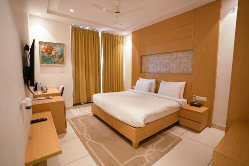 a hotel room with a bed and a window at Annekaa Heights in Vrindāvan