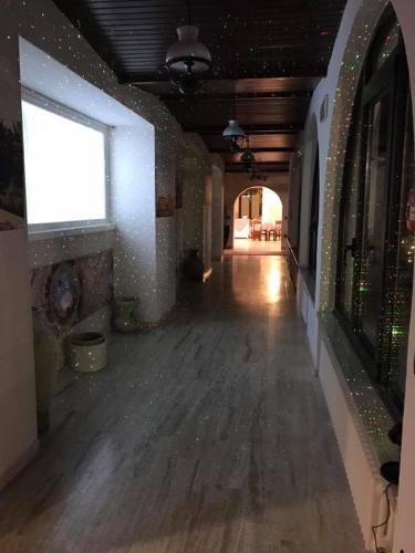 an empty room with a wooden floor and a window at Hotel Ristorante La Grotta in Castiglione delle Stiviere