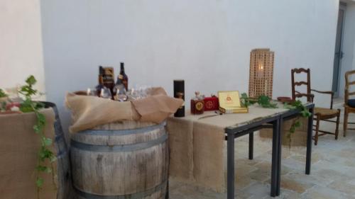 a table with wine bottles on top of a barrel at Masseria Celentano Relais & Agriturismo in San Severo