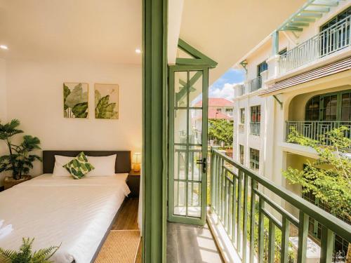 a balcony with a bed and a window at Hana Village Garden Tropical Bãi Khem in Phú Quốc