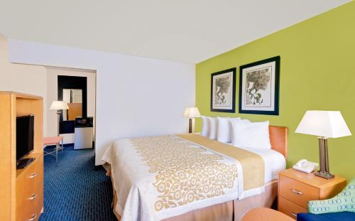 a hotel room with a bed and a television at Days Inn by Wyndham Easton in Easton