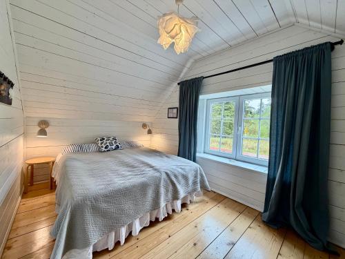 a bedroom with a bed and a window at Bla Marine Domki nad Morzem in Grzybowo